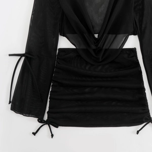Detail of black mesh long sleeve crop top and mini skirt with drawstring ruching
