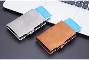 Macro view of RFID-blocking card holders in grey and brown leather with pop-up mechanism