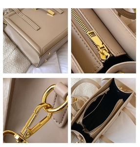 Detailed close-up of khaki shoulder bag featuring gold hardware and interior pockets