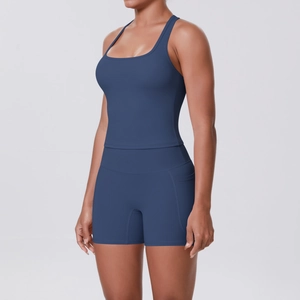 Detail view of high-waist navy yoga shorts with side pocket and racerback sports bra