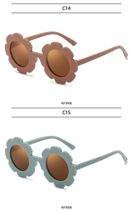 Detail of flower-shaped kids sunglasses in dusty pink and light blue at 45-degree angle