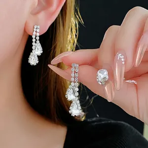Elegant silver teardrop drop earrings with sparkling pavé crystals and pear-cut stones