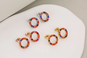 Detailed view of three pairs of round stud earrings in silver, rose gold, and gold finishes