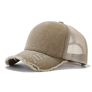Vintage washed cotton trucker hat with distressed brim and beige breathable mesh back