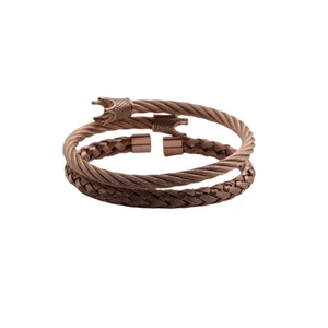 Detail of rose gold double cable bangle featuring intricate crown shaped end charms