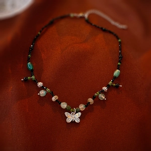 Vintage style butterfly necklace with green jade beads and antique silver pendant