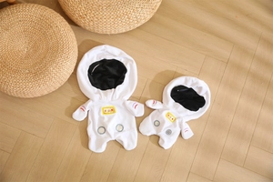 Detailed view of astronaut-themed plush toy shells set on a light wooden background