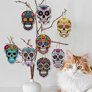 Set of 8 colorful Day of the Dead skull ornaments hanging on branches for party decor
