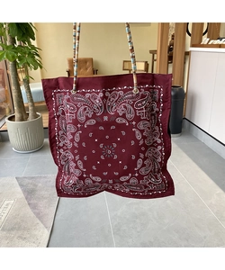 Detail of burgundy paisley tote bag with vintage colorful beaded handle and metal rings