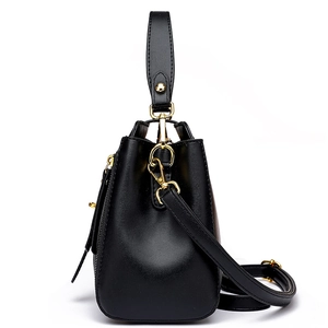 Elegant black quilted leather bucket bag with gold hardware and a detachable strap