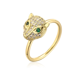 Macro detail of 18K gold leopard ring featuring green zircon eyes and micro-pave stones