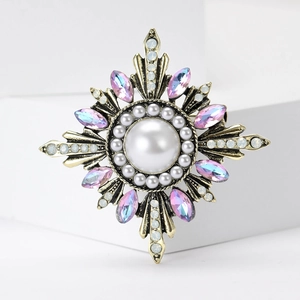 Vintage Baroque sunburst brooch with center pearl and purple gradient crystals on gold base