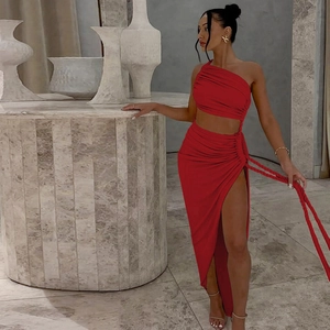 Detail of red one-shoulder dress showing waist cutout and ruched fabric texture