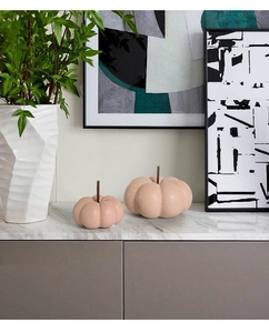 Detailed close-up of ceramic pumpkin decor set on marble with morandi pink finish