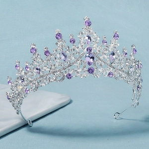Detailed view of luxury silver tiara featuring purple crystals and sparkling rhinestones