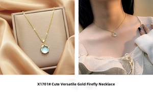 Detail of gold firefly necklace with blue stone on silk and worn by model
