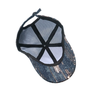 Internal view of blue denim baseball cap showing reinforcement and gold sequins