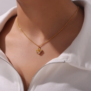 Gold-plated clover pendant necklace with sparkling cubic zirconia on a minimalist blade chain