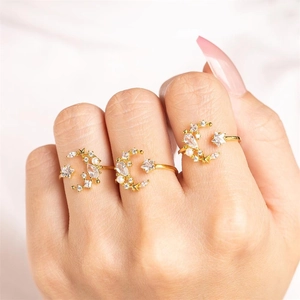 Detail of adjustable gold-plated moon and star rings with pearls and zircon stones
