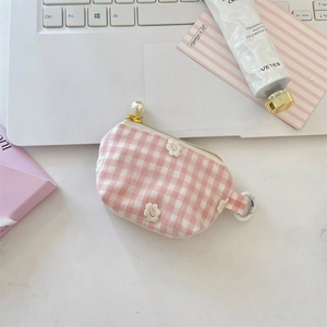 Detail of pink plaid mini pouch with white flower embroidery and pearl zipper pull