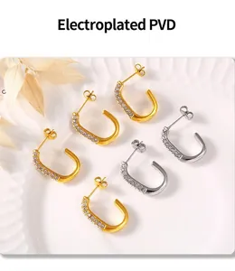 Detail of PVD electroplated U-shaped earrings in gold and silver with diamond accents