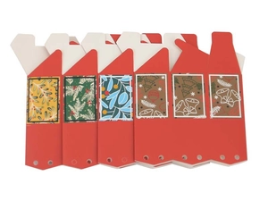 Close-up of six red Christmas candy boxes with hollow windows and festive patterns