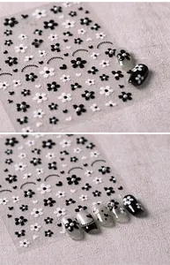 Detail of vintage French black and white floral nail stickers with pearl accents