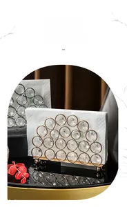 Detailed close-up of a modern crystal napkin holder with a luxury gold metal finish