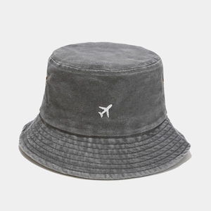 Détail du chapeau bob en coton délavé avec broderie avion blanc et œillets d'aération