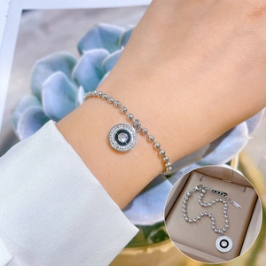 Close-up of a titanium steel roman ring bracelet with zircon inlay on a beaded chain