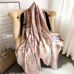 Elegant floral silk satin scarf for women styled on a chair in a chic lifestyle setting