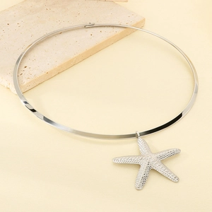 Macro shot of polished silver starfish pendant on a rigid stainless steel choker neckband