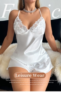 Detailed shot of white satin pajama set with delicate lace trim on model