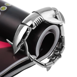 Macro shot of silver stainless steel scorpion bone bracelet on a black magazine