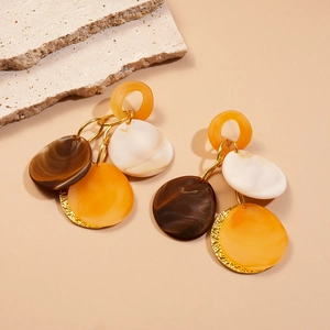 Vue détaillée des boucles d'oreilles géométriques Maillard en acrylique et métal doré