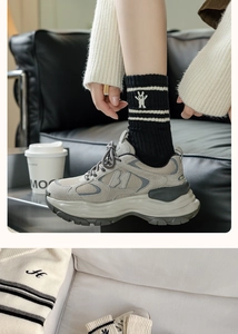 Detail showing grey casual sneakers with cute rabbit embroidered striped mid-calf socks