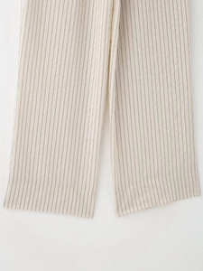 Detail of vertical striped wide leg pants featuring premium stitching and hem finishing