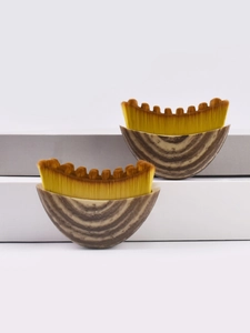 Detail of crescent lymphatic foundation brushes with dense gradient bristles and wood grain handle