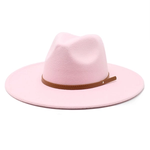 Detailed macro view of pink fedora featuring brown leather strap and silver metal rivets