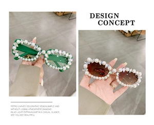 Detail of square oversized sunglasses with faux pearls and rhinestones on the frames