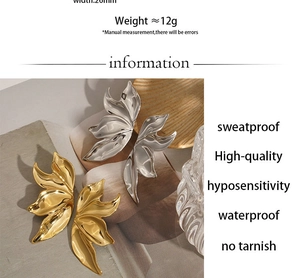 Detailed macro of 26mm leaf-shaped earrings in polished gold and silver finishes