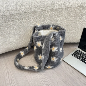 Macro detail of the grey faux shearling daisy tote bag featuring a secure magnetic closure