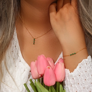Detail of 18K gold-plated necklace and bracelet set with green water-drop gems