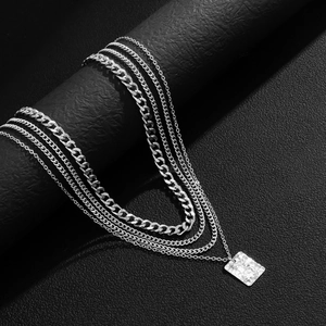 Silver multi-layer Cuban chain necklace set with a textured square pendant on black leather