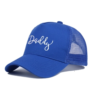 Close-up of royal blue trucker hat with white Daddy embroidery and breathable mesh