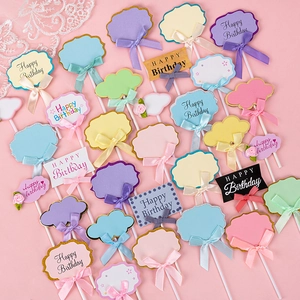 Set of DIY birthday cake toppers with colorful ribbons and glitter borders on pink background