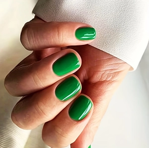 Close-up of vibrant lime green glossy almond press-on nails on white fabric sleeve