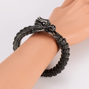 Retro dragon scale bracelet with silver dragon head carving on a model hand