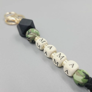 Macro detail of MAMA beaded keychain with camo silicone beads and golden metal clasp