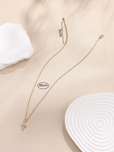 Detail of gold cross pendant necklace with zirconia and 40cm chain plus 5cm extension